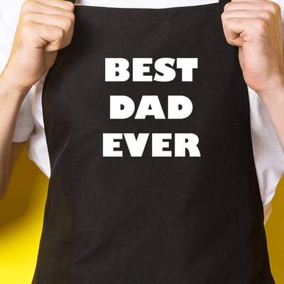 Zwart keukenschort / BBQ-schort met tekst | Best dad ever | Katoen - One size - Verstelbaar - Wasbaar - Cadeau voor hem - Vaderdag - Gratis verzending - Cadeau voor Kerst & sinterklaas | Incl. 2 jaar garantie
