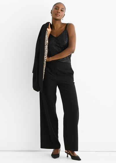 Zwarte cape-blazer met contrasterende dierenprint voering