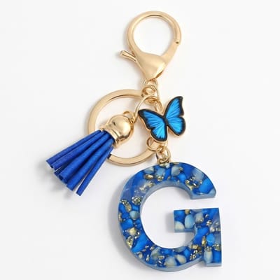 Blauwe letter G sleutelhanger met kwastje en vlinder – sleutelhanger voor dames – goudkleurige metalen keychain met acryl initiaal G hanger, decoratieve bedel en tassel