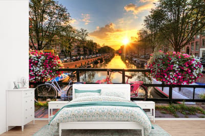 Behang - Fotobehang Amsterdam - Bloemen - Brug - Fiets - Zonsondergang - Breedte 330 cm x hoogte 220 cm