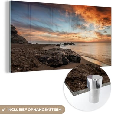 MuchoWow® Glasschilderij 40x20 cm - Schilderij acrylglas - Strand - Stenen - Avond - Lucht - Natuur - Foto op glas - Schilderijen