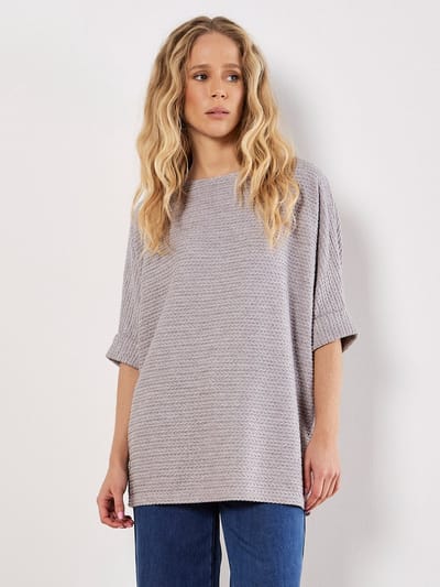 Oversized top met vleermuismouwen en kabelpatroon