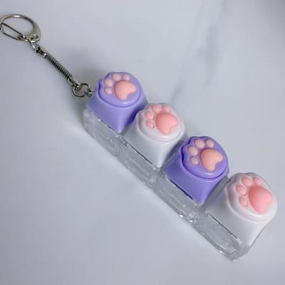 2-delige sleutelhanger met kattenpootjes | Met decompressieknop | Leuke ontwerp, geschikt voor dagelijks gebruik en accessoire-Paars-wit-paars-wit