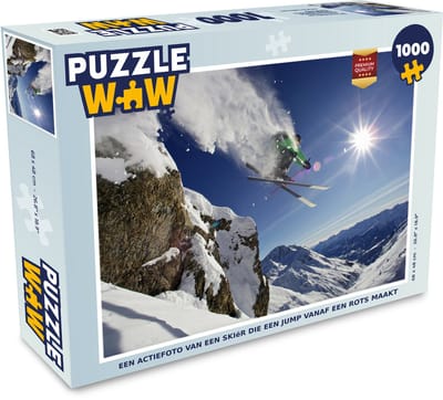 Puzzel Een actiefoto van een skiër die een jump vanaf een rots maakt - Legpuzzel - Puzzel 1000 stukjes volwassenen