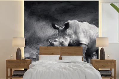 Behang - Fotobehang Neushoorn - Natuur - Gras - Zwart - Wit - Breedte 220 cm x hoogte 220 cm