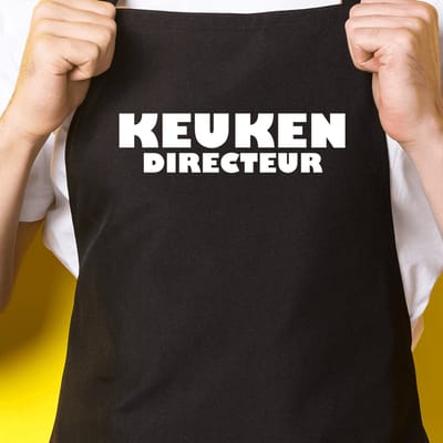 Zwart keukenschort / BBQ-schort met tekst | Keuken directeur | Katoen - One size - Verstelbaar - Wasbaar - Cadeau voor hem - Vaderdag - Gratis verzending - Cadeau voor Kerst & sinterklaas | Incl. 2 jaar garantie