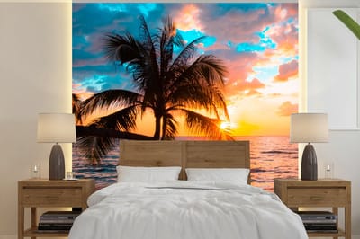 Behang - Fotobehang Palm - Zonsondergang - Horizon - Strand - Zee - Tropisch - Breedte 240 cm x hoogte 240 cm