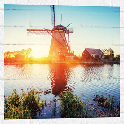 WallClassics - Muursticker - Zonlicht langs Hollandse Molen aan het Water - 50x50 cm Foto op Muursticker