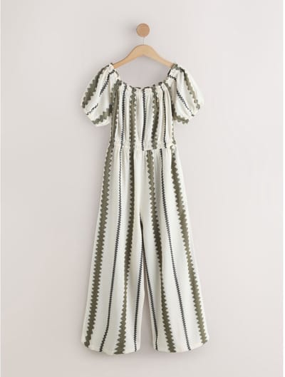 Next - Dames - Petite jumpsuit met blote schouder en wijde pijpen - Petite - Crème