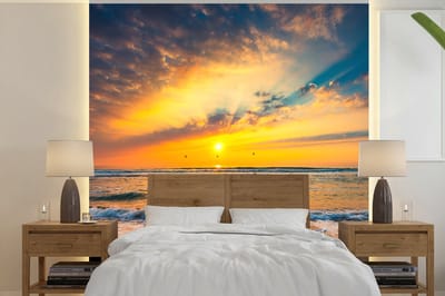 Behang - Fotobehang Zonsondergang - Strand - Zee - Wolken - Oranje - Breedte 350 cm x hoogte 350 cm
