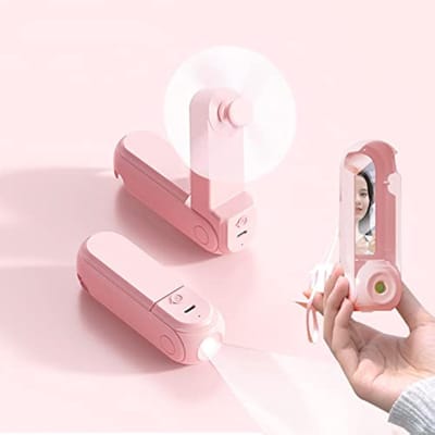 Handventilator, 4-in-1 draagbare persoonlijke ventilator met spiegel, zaklamp en telefoonhouder, mini opvouwbare bureauventilator, werkt op een oplaadbare USB-batterij, 6-20 uur batterijduur, geschikt voor reizen en kamperen (roze).