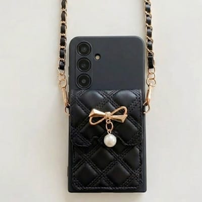 Zwart telefoon hoesje geschikt voor Samsung Galaxy A55 – backcover voor dames – doorgestikt lederlook design – goudkleurige strik met parel – hoesje met schouderkoord