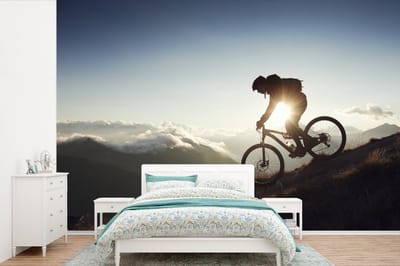 Behang - Fotobehang Fietsen vanaf de berg op een mountainbike - Breedte 420 cm x hoogte 280 cm