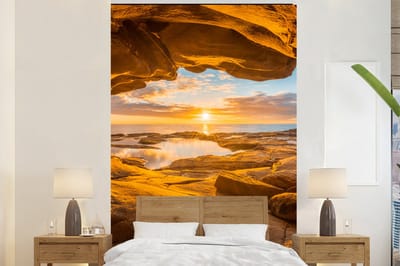 Behang - Fotobehang Grot - Zee - Horizon - Zonsondergang - Breedte 195 cm x hoogte 300 cm