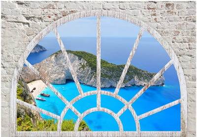 Fotobehangkoning - Behang - Vliesbehang - Fotobehang Uitzicht op Shipwreck Beach vanuit het Raam 3D - Look At The Island Of Dreams - 300 x 210 cm