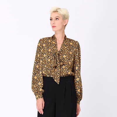 Ascot-tie blouse en kunst-deco print
