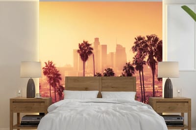 Behang - Fotobehang Palmboom - Skyline - Zonsondergang - Architectuur - Breedte 300 cm x hoogte 300 cm