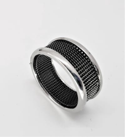 Edelstaal brede zilverkleurig ring maat 18 met zwart gaas in midden, beide zijkant iets hoog zilverkleur, door zwart in combinatie met zilverkleurig rand maakt deze ring een chique uitstraling.