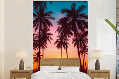Behang - Fotobehang Palmboom - Zonsondergang - Horizon - Strand - Oranje - Roze - Breedte 195 cm x hoogte 300 cm
