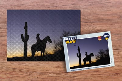 Puzzel Silhouet van een cowboy bij een cactus met zonsondergang - Legpuzzel - Puzzel 1000 stukjes volwassenen