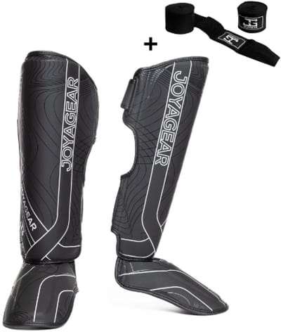 Joya ESSENTIAL Scheenbeschermers – Maat S – Zwart/Wit – Kickboksen/Muay Thai/MMA – Ergonomische pasvorm, schokabsorberende padding – Inclusief Bandage