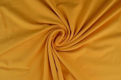 Katoen tricot stof - Okergeel - 10 meter