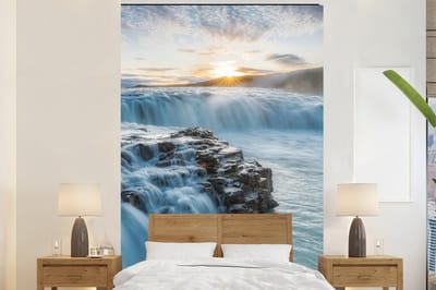 Behang - Fotobehang Waterval - Water - Stenen - Zon - Natuur - Breedte 195 cm x hoogte 300 cm