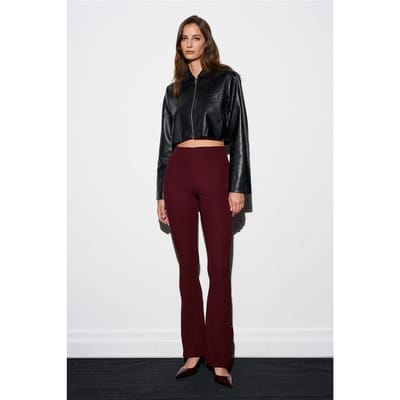 Hoog-getailleerde flare leggings met knoopdetail