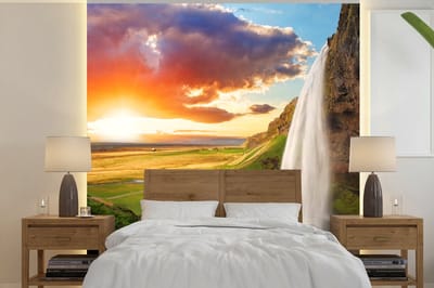 Behang - Fotobehang Waterval - Rots - Zonsondergang - Bergen - Oranje - Breedte 240 cm x hoogte 240 cm