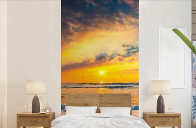 Behang - Fotobehang Zonsondergang - Strand - Zee - Wolken - Oranje - Breedte 120 cm x hoogte 240 cm