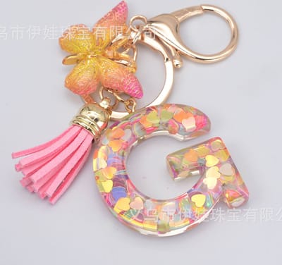 Sleutelhangers of voor je tas van A tot Z - met een pompon of kwastje - met letter - mooi design - handgemaakt - sleutelhangers - design - mode - goud - zwart - blauw - roze- rood