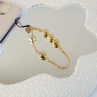 xoxo Wildhearts koord - Gold Hearts - Phone Charm (small) - bedeltje geschikt voor iPhone - Ketting met hartjes - kort telefoonkoord geschikt voor Samsung - geschikt voor alle telefoonmodellen - Goud