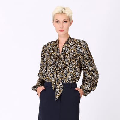 Ascot-tie blouse en kunst-deco print