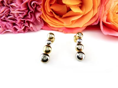 oorringen in geel en wit goud gezet met diamant