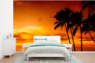 Behang - Fotobehang Palmboom - Zonsondergang - Tropisch - Oranje - Zee - Breedte 295 cm x hoogte 220 cm