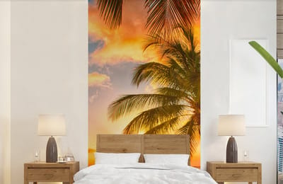 Behang - Fotobehang Zonsondergang - Palmboom - Wolken - Zee - Strand - Breedte 120 cm x hoogte 240 cm