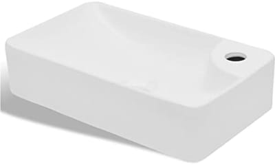 Witte keramische wastafel met kraangat
