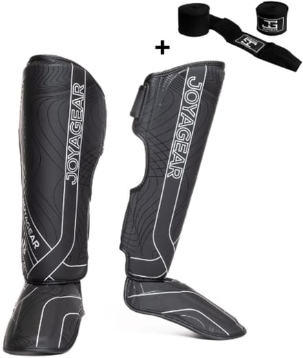 Joya ESSENTIAL Scheenbeschermers – Maat S – Zwart/Wit – Kickboksen/Muay Thai/MMA – Ergonomische pasvorm, schokabsorberende padding – Inclusief Bandage