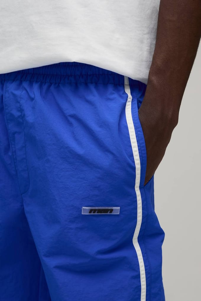 Relaxed Fit Side Stripe Logo Print Nylon Track Pants | Blue | Size Medium