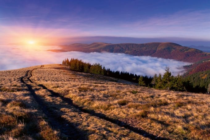 Fotobehang - Sunrise in Mountains 375x250cm - Vliesbehang