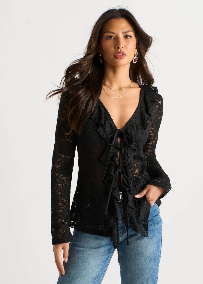 Zwarte jersey blouse met ruches en strik aan de voorkant