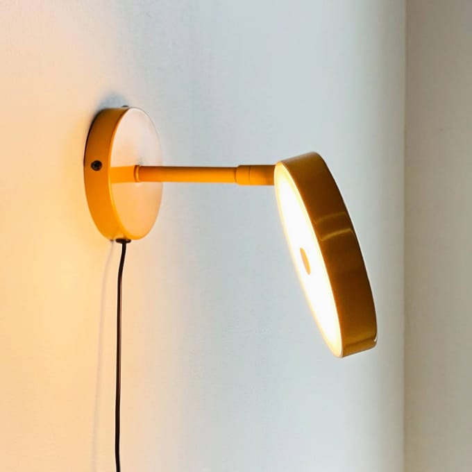 Dyberg Larsen LED wandlamp Starlight, geel, Ø 14 cm, dimbaar.