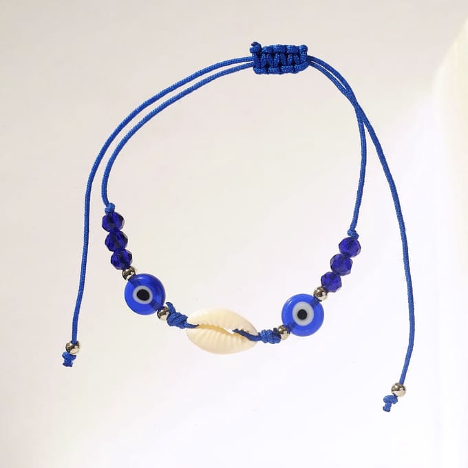 Blauw armbandje met kauri schelp en boze oog kralen