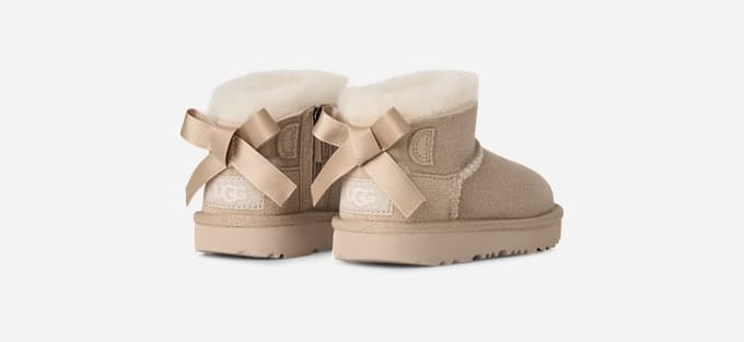 UGG® Ultra Mini Bailey Bow Boot in Tan, Size 8, Polyester/Wool