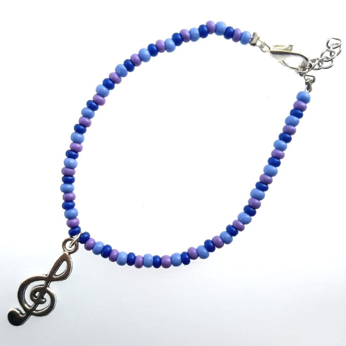 Armband - paarstinten met muzieksleutel