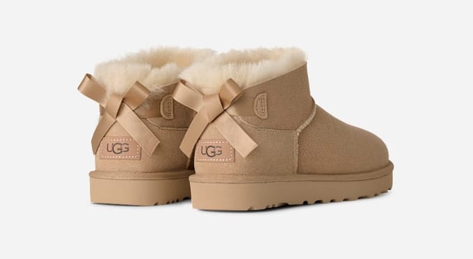 UGG® Ultra Mini Bailey Bow Boot in Tan, Size 3, Polyester/Leather
