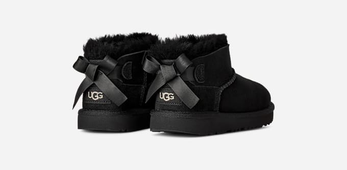 UGG® Ultra Mini Bailey Bow Boot in Black, Size 2, Polyester/Wool