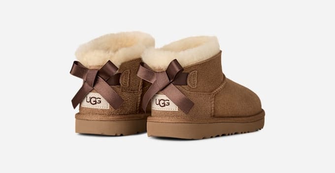 UGG® Ultra Mini Bailey Bow Boot in Brown, Size 1, Polyester/Wool