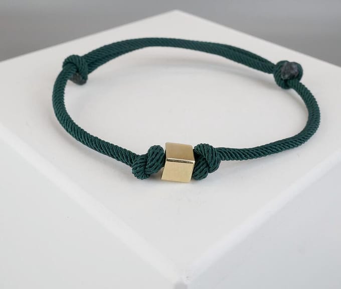 Donker groene armband met gouden kubus