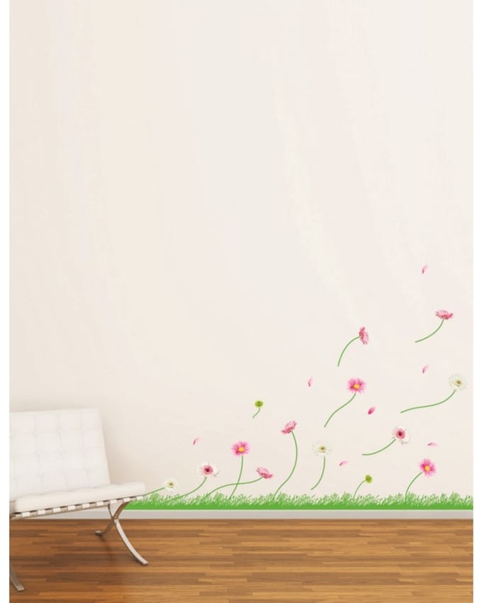 Decoratieve muurstickers met kleurrijke gerbera's en gras.